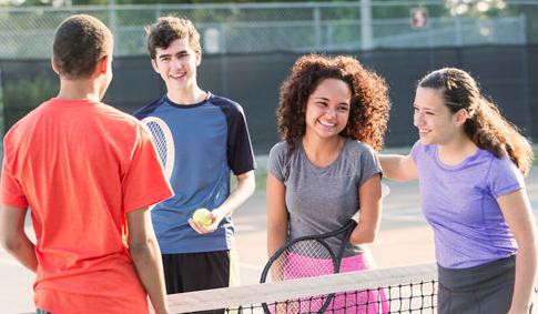 Teens playing tennis
